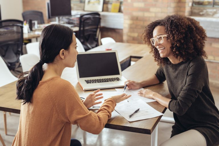 une femme parle avec son agente dans un bureau