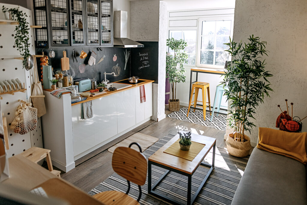 Scandinavian interior style modern studio small apartment in white and grey colors, furniture in living area and kitchen area