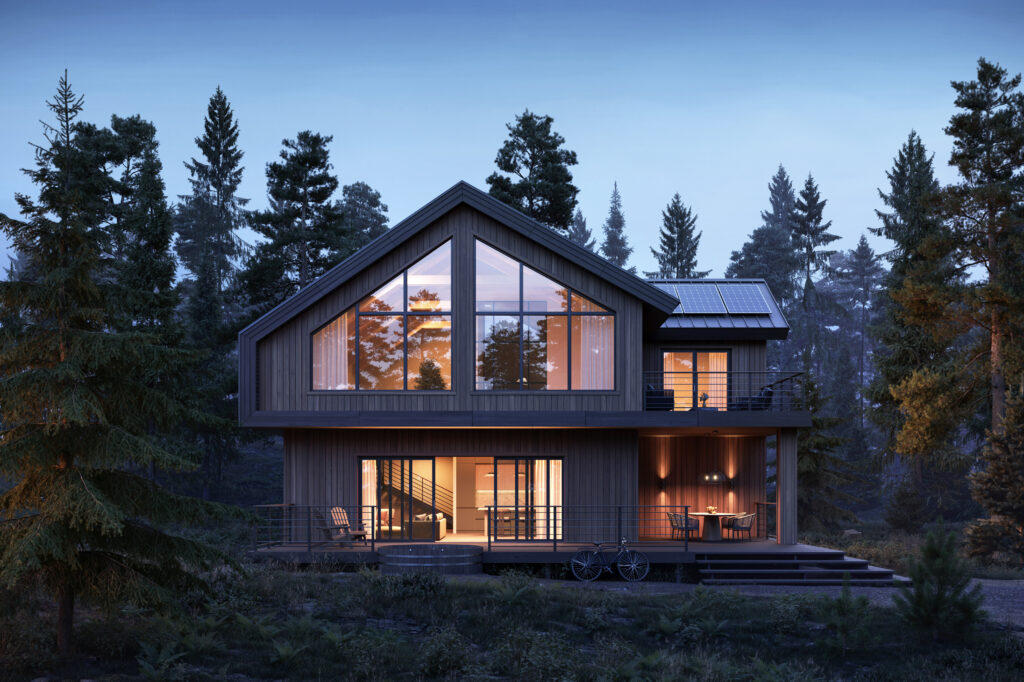 Une maison aux grandes fenêtres, entourée d'arbres, la nuit